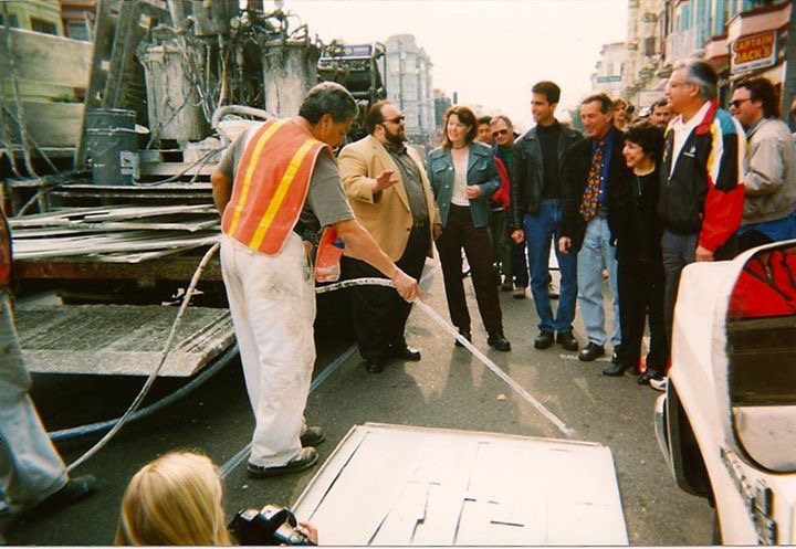 Mary Brown, in the green jacket, watches as the bike lanes she organized for are striped on Valencia in 1999.