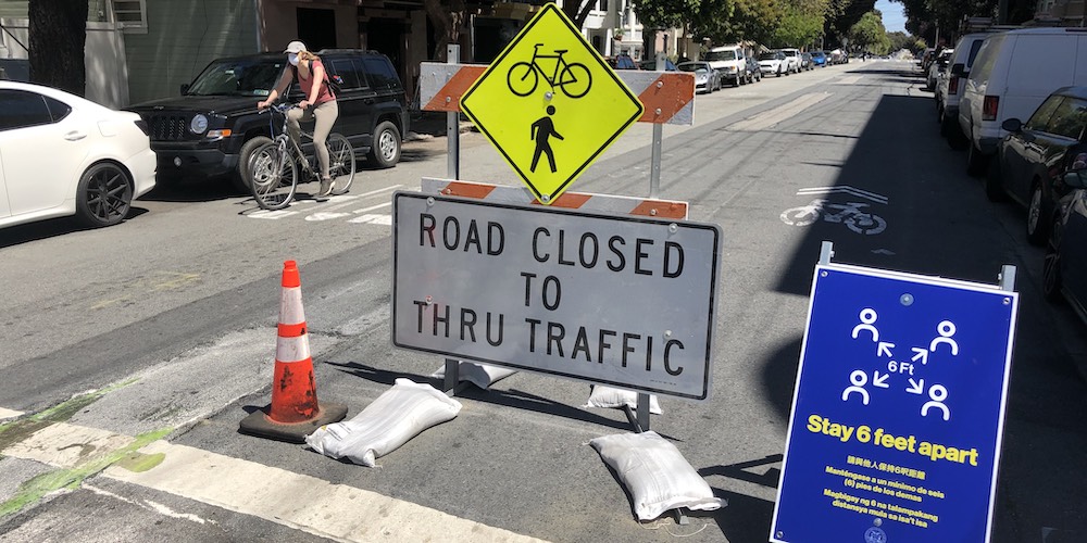 Photo of a sign at the start of a Slow Street that reads "Road Closed to Thru Traffic"