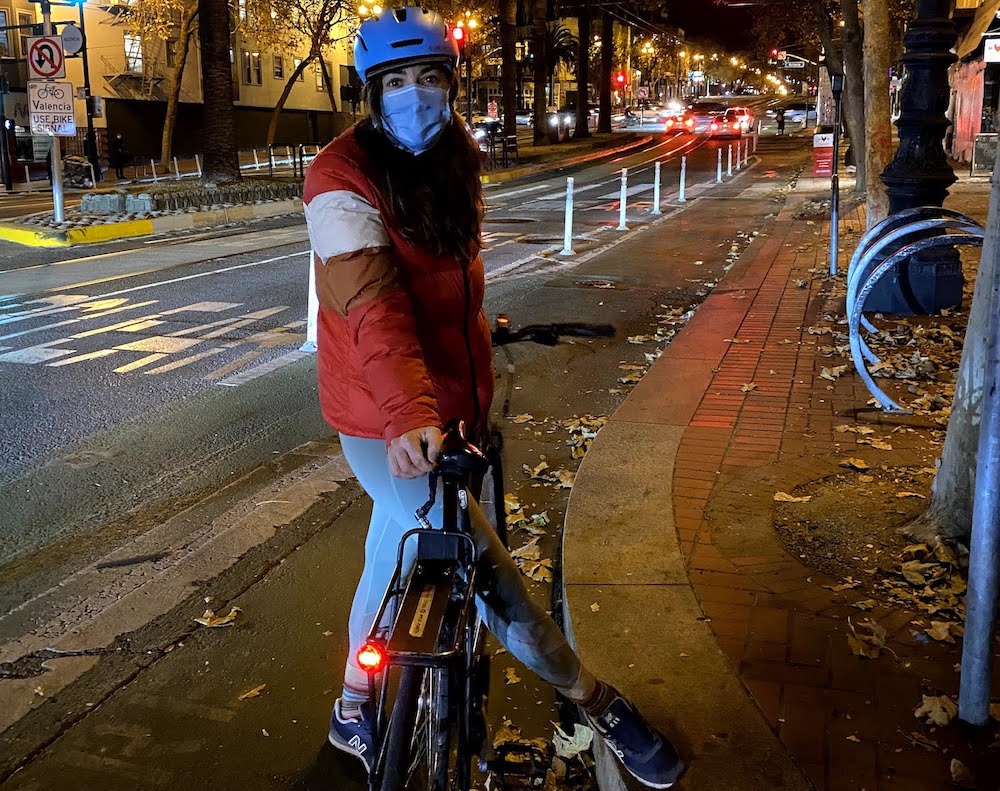 woman with bike at night