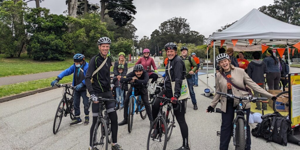 Photo of people on bikes smiling.