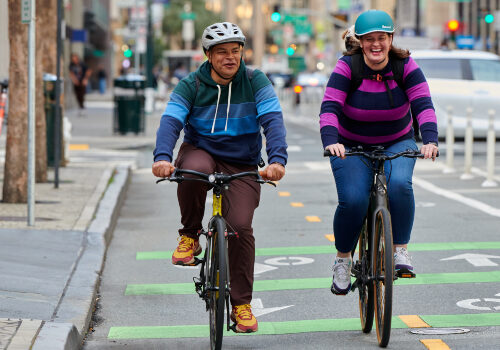 two people riding in a two-way bike lane in downtown San Francisco